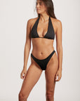 Woman wearing a black bikini against a white background
