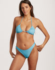 Woman wearing a blue bikini against a white background